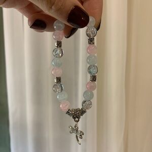 Pink and blue beaded bracelet with dragonfly charm.